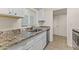 White kitchen cabinets with granite countertops and stainless steel appliances at 6547 N 3Rd Ave, Phoenix, AZ 85013