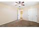 Well-lit bedroom with carpet, ceiling fan and double doors at 6741 W Charter Oak Rd, Peoria, AZ 85381