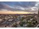 Aerial view of the community featuring a sunset sky, landscaping, and nearby buildings at 7181 E Camelback Rd # 904, Scottsdale, AZ 85251
