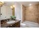 Bathroom with soaking tub and dark vanity at 7181 E Camelback Rd # 904, Scottsdale, AZ 85251