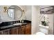 Modern bathroom with a sleek vanity and round mirror at 7181 E Camelback Rd # 904, Scottsdale, AZ 85251