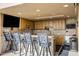 Community kitchen with bar seating and modern appliances at 7181 E Camelback Rd # 904, Scottsdale, AZ 85251