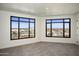 Empty room featuring large windows offering a picturesque city view at 7181 E Camelback Rd # 904, Scottsdale, AZ 85251