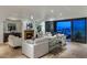 Bright living room with a fireplace and access to a balcony with city views at 7181 E Camelback Rd # 904, Scottsdale, AZ 85251