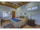 Primary bedroom with a king-size bed and wood beam ceiling at 7500 E Boulders Pkwy # 23, Scottsdale, AZ 85266