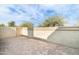 Private patio with brick pavers and stucco wall at 7760 E Pepper Tree Ln, Scottsdale, AZ 85250