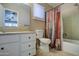 Bathroom with white vanity, shower/tub combo, and colorful curtain at 8050 S Bianco Rd, Casa Grande, AZ 85193