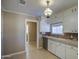 Bright kitchen features white cabinets and vintage pendant light at 8050 S Bianco Rd, Casa Grande, AZ 85193