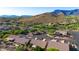 Aerial view of a community with houses, roads, and mountain views at 8637 E Golden Cholla Cir, Gold Canyon, AZ 85118