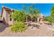 Landscaped backyard featuring a covered patio and mature plants at 8637 E Golden Cholla Cir, Gold Canyon, AZ 85118
