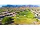 Aerial view of a golf course with houses and mountain backdrop at 8637 E Golden Cholla Cir, Gold Canyon, AZ 85118