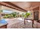 Large covered patio with tile flooring and outdoor furniture at 8637 E Golden Cholla Cir, Gold Canyon, AZ 85118