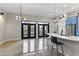 Open concept dining area with modern pendant lights and access to a balcony at 914 E Osborn Rd # 208, Phoenix, AZ 85014