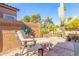 Relaxing backyard patio with seating area, stone flooring, and desert landscaping at 9428 W Taro Ln, Peoria, AZ 85382
