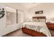 Bright bedroom with wood bed frame and window at 9428 W Taro Ln, Peoria, AZ 85382