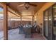 Covered patio with dining table, ceiling fan, and stone floor at 9428 W Taro Ln, Peoria, AZ 85382