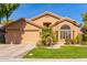 Tan house with a two-car garage and palm tree landscaping at 9428 W Taro Ln, Peoria, AZ 85382