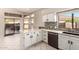 White kitchen with stainless steel appliances and marble countertops at 9428 W Taro Ln, Peoria, AZ 85382