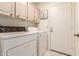 Laundry room with washer, dryer, and cabinets at 9428 W Taro Ln, Peoria, AZ 85382