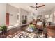 Bright and airy living room with hardwood floors and access to other rooms at 9428 W Taro Ln, Peoria, AZ 85382