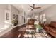 Relaxing living room with hardwood floors, comfortable seating, and natural light at 9428 W Taro Ln, Peoria, AZ 85382