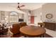 Spacious living room with hardwood floors and a view to the kitchen and dining area at 9428 W Taro Ln, Peoria, AZ 85382