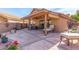 Spacious covered patio with dining furniture and relaxing lounge chair at 9428 W Taro Ln, Peoria, AZ 85382