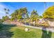 Landscaped pond with a wooden footbridge and waterfall feature at 9428 W Taro Ln, Peoria, AZ 85382