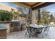 Outdoor kitchen with built-in grill and seating at 10585 E Crescent Moon Dr # 19, Scottsdale, AZ 85262