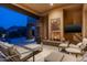Covered patio with fireplace, comfortable seating and mountain views at 10585 E Crescent Moon Dr # 19, Scottsdale, AZ 85262