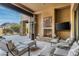 Covered patio with fireplace and mountain views at 10585 E Crescent Moon Dr # 19, Scottsdale, AZ 85262