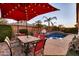 Landscaped backyard with a pool, dining table, and lush greenery creating a private outdoor oasis at 10851 E Sonrisa Ave, Mesa, AZ 85212