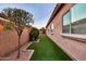 Side yard with artificial grass and landscape lighting at 10851 E Sonrisa Ave, Mesa, AZ 85212