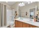 This well-lit bathroom offers a double sink vanity, shower over tub, and a large mirror at 10851 E Sonrisa Ave, Mesa, AZ 85212