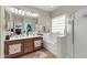 Bathroom featuring a soaking tub, double sink vanity, a walk-in shower, and bright natural light from window at 10851 E Sonrisa Ave, Mesa, AZ 85212