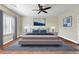 Serene bedroom with a large window, ceiling fan, and contemporary decor for a relaxing ambiance at 10851 E Sonrisa Ave, Mesa, AZ 85212