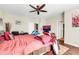 Bedroom featuring a ceiling fan, a large bed, and bright natural light from window at 10851 E Sonrisa Ave, Mesa, AZ 85212