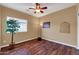 Bedroom featuring wood floors, ceiling fan, and bright natural light from window at 10851 E Sonrisa Ave, Mesa, AZ 85212