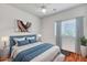 Bright bedroom featuring a cozy bed, modern decor, and a window with stylish curtains at 10851 E Sonrisa Ave, Mesa, AZ 85212
