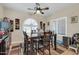 Cozy dining room with a large table, ceiling fan and lots of light from the windows at 10851 E Sonrisa Ave, Mesa, AZ 85212