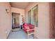 Inviting covered entryway featuring a bench, security door, and a pleasant, welcoming ambiance at 10851 E Sonrisa Ave, Mesa, AZ 85212