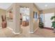 Hallway view with a partial view of the kitchen, tile flooring, and natural light at 10851 E Sonrisa Ave, Mesa, AZ 85212