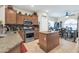Kitchen with wood cabinets, granite countertops, stainless steel appliances, and center island at 10851 E Sonrisa Ave, Mesa, AZ 85212