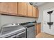 A laundry room with a washer and dryer, storage cabinets, and counter space at 10851 E Sonrisa Ave, Mesa, AZ 85212