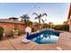 Beautiful backyard pool area with palm trees, water feature, and warm string lights, perfect for relaxation at 10851 E Sonrisa Ave, Mesa, AZ 85212