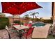 Inviting backyard patio with outdoor seating and pool area, perfect for relaxing and entertaining under the lights at 10851 E Sonrisa Ave, Mesa, AZ 85212