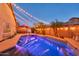 Inviting backyard pool and patio area featuring string lights, palm trees, and lounge furniture at 10851 E Sonrisa Ave, Mesa, AZ 85212