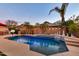 Backyard pool reflecting the evening sky, surrounded by palm trees and soft lighting for a relaxing ambiance at 10851 E Sonrisa Ave, Mesa, AZ 85212