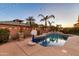 Backyard pool area with a basketball hoop, palm trees, and landscape, ideal for recreation and relaxation at 10851 E Sonrisa Ave, Mesa, AZ 85212