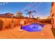 Backyard pool and patio area featuring string lights, palm trees, and a basketball hoop at 10851 E Sonrisa Ave, Mesa, AZ 85212